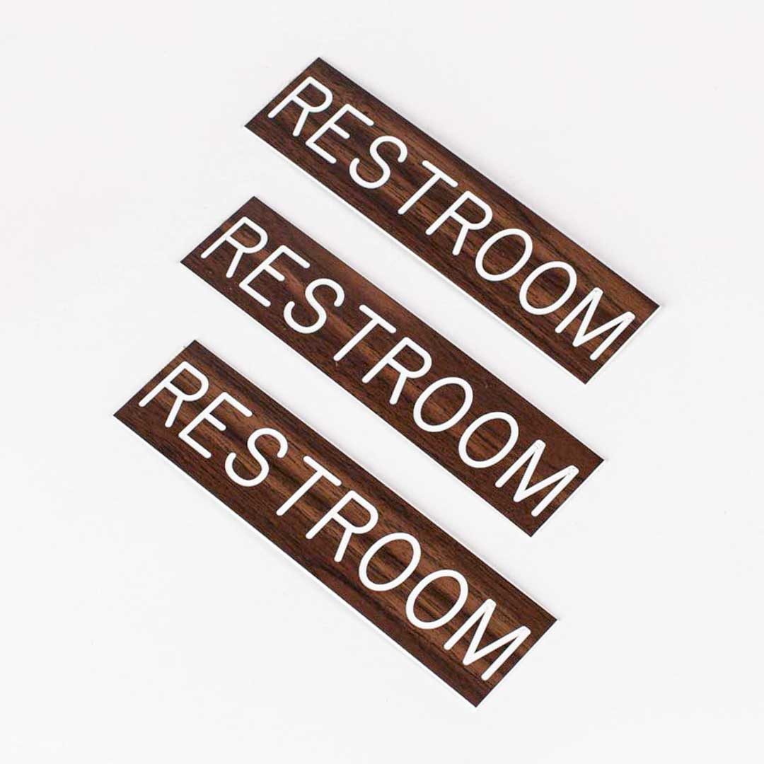SIGN ENGRAVED RESTROOM ADHESIVE BACK WALNUT