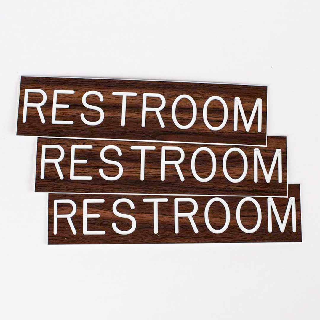 SIGN ENGRAVED RESTROOM ADHESIVE BACK WALNUT