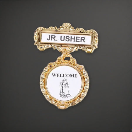 Badge - Fancy Round - Jr. Usher - Praying Hands Welcome - Pin on a charcoal backdrop