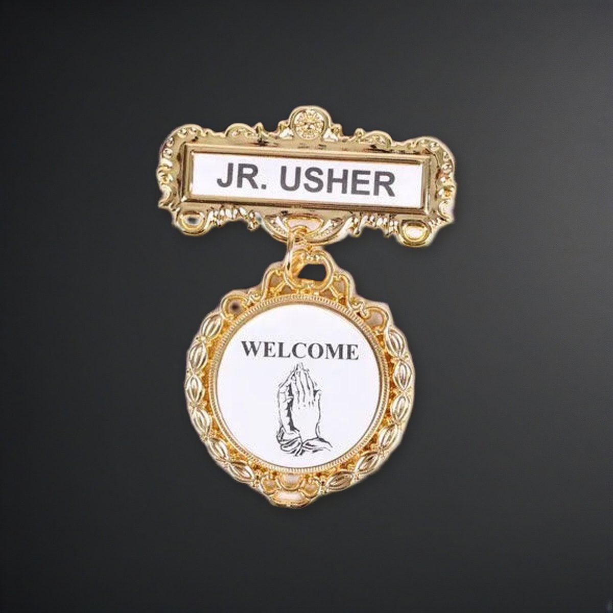 Badge - Fancy Round - Jr. Usher - Praying Hands Welcome - Pin on a charcoal backdrop