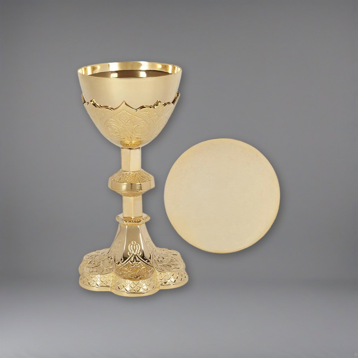 Vine Embossed Chalice and Paten Set on a soft grey backdrop
