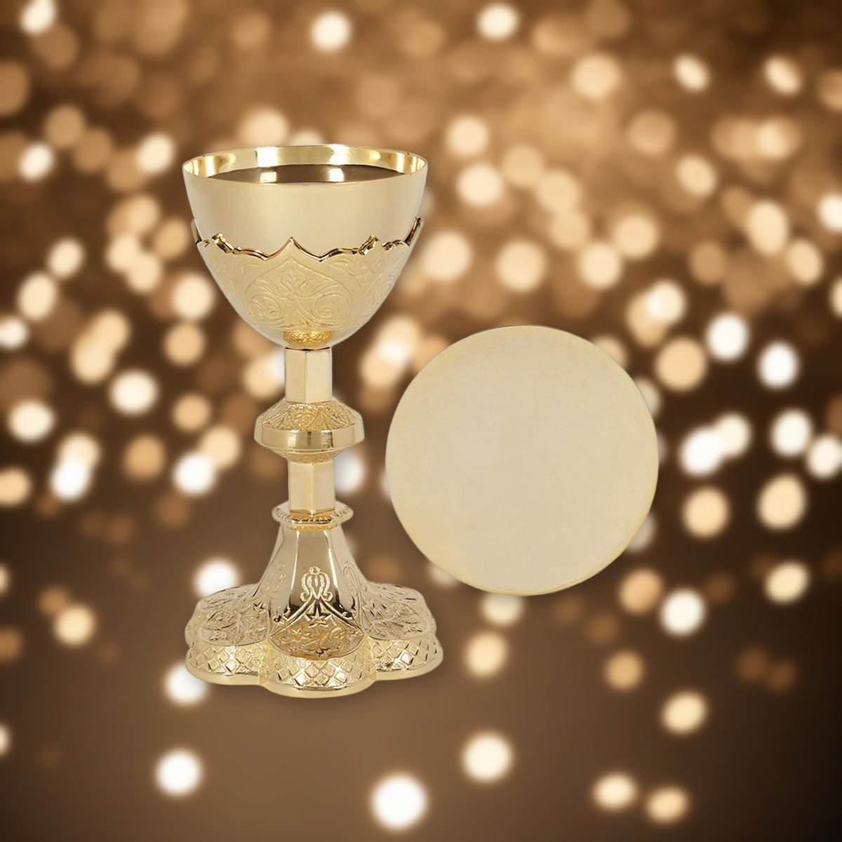Vine Embossed Chalice and Paten Set against soft golden light